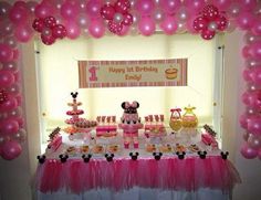 a minnie mouse themed birthday party with balloons