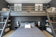 a bedroom with bunk beds and ladders in it