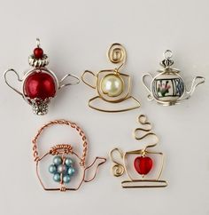 several different types of ornaments are shown on a white surface, including teapots and coffee mugs