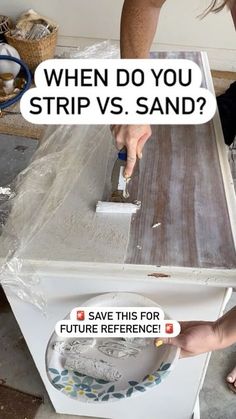 a person using a brush to paint a piece of wood on top of a stove