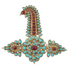 Rare Indian gold, ruby and turquoise Sarpech turban ornament Indian, 19th Century Sarpech: height 12cm, width 14cm, depth 0.5cm Case: height 19cm, width 20cm, depth 4cm Similar to works in the Royal Collection, this beautiful ornament is a nineteenth century Indian Sarpech. Crafted from gold, rubies, and turquoises, it is intended as a piece to adorn the front of a turban, although often these fine items of religious jewellery find themselves other purposes. The two side panels towards the base are mounted on hinges, and share a similar design to the central element, with a single ruby in the centre surrounded by rings of turquoise. The long neck of the piece arcs to the left, finishing with a large round and more prominent ruby, like the eye in a bird's head. With a similar appearance to Royal Jewelry Indian, Mughal Jewelry, Vintage Tiara, Tiaras Jewellery, Hair Jewels, The Royal Collection, Turquoise And Gold, Indian Crafts, Indian Necklace