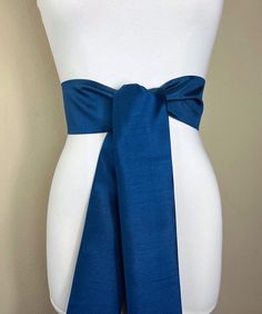 "Wide Textured Deep Sea Blue Sash Belt  Dark Blue Dupioni Sash  Blue Dress Sash  Dupioni Fabric Belt  Blue Wedding & Bridesmaid  Satin Swank  Add vibrant color and crisp texture to your special occasion outfit with this Satin Swank® dupioni waist sash. Depending on your waist size and the length you choose (75 and 90 inch lengths available), you can wrap this sash around your waist once or twice. You decide whether to tie the sash in a bow or a simple knot with long-hanging tails. Tie in front, in back, or on the side. A double layer of crisp dupioni fabric in deep sea blue. Sash is the same front and back with seams hidden within the fold lines. Dupioni features a rustic weave with naturally occurring slubs running throughout the fabric resulting in exquisite depth, texture, and sheen. SI Colbolt Blue Belt With Sea Glass, Navy Blue Belly Sash, Wedding Dress Blue Sash, Blue Embroidered Sash, Blue Flower Belt, Bridesmaid Satin, Waist Sash, White Bridesmaid Dresses, Dress Sash