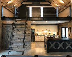 an open loft with stairs leading up to the kitchen