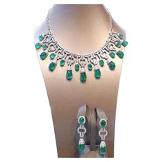 An exceptional Art Deco style parure, complete with earrings and necklace, so stunning and refined , a very piece of art. Necklace come in 18k gold with natural emeralds from Zambia, extra fine quality, in cabochon cut , Ceo Minor, of 91,85 carats, and 640 pieces of natural diamonds of 8,52 carats, F color and VS clarity. Earrings come in 18k gold with 4 pieces of natural emeralds from Zambia, extra fine quality ,Ceo Minor , of 26,76 carats, and 140 pieces of natural diamonds of 1,96 carats, rou Dazzling Formal Emerald Gemstone Necklace, Emerald Diamond Necklace For Formal Occasions, Formal White Gold Emerald Necklace, Exquisite Diamond And Emerald Formal Necklace, Exquisite Diamond Emerald Necklace For Formal Occasions, Formal Emerald Diamond Necklace In White Gold, Exquisite Emerald Necklace With Diamonds For Formal Events, Formal White Gold Emerald Diamond Necklace, Luxury White Gold Jewelry Sets With Elegant Design