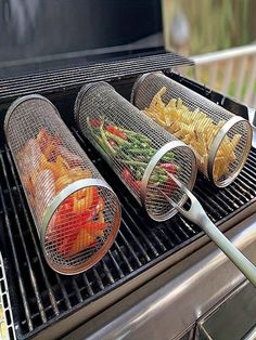 three baskets filled with food sitting on top of an outdoor bbq grill next to fries