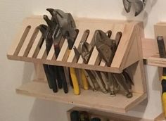 tools are stored on wooden shelves in a workbench with screwdrives and pliers