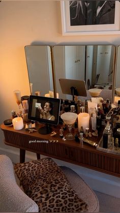 a vanity with candles and pictures on it