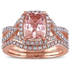 a pink diamond ring set on top of a rose gold plated ring with diamonds around the band