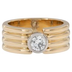 a gold ring with a white diamond in the center