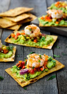 shrimp and guacamole on tortilla chips with avocado garnish