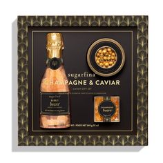 the champagne and caviar gift set is displayed in a black box with gold trimming