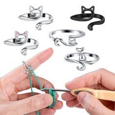 a person is knitting with scissors and cat rings