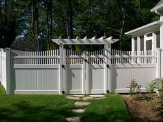 a white picket fence in front of a house