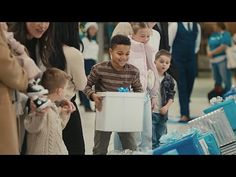 a group of people standing next to each other in front of boxes and suitcases