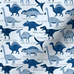 a blue and white fabric with dinosaurs on it