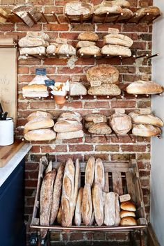 breads and loaves on display in a bakery