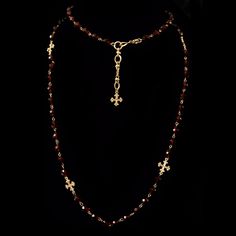 The Fleur de Lis Cross Wrap Necklace feature facete Garnet Crystals beads and is 39" long and can be worn day or night. Pair it with our Garnet Sacred Heart Cross Necklace or any of our gold layers. This wrap can be worn as a long necklace, double wrapped or as wrap bracelet. 8mm Garnet Crystals and 39" long with adjustments to 45" with built in Fleur de Lis extender Crosses and Claps are Sterling Silver Clad over Bronze Gothic Moodboard, Garnet Necklace Gold, Vintage Cross Necklace, Heart Cross Necklace, Gold Rosary, Crystals Beads, Garnet Crystal, Wrap Necklace, Garnet And Gold