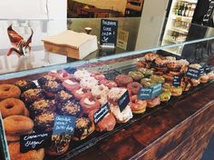 a display case filled with lots of different types of doughnuts and pastries