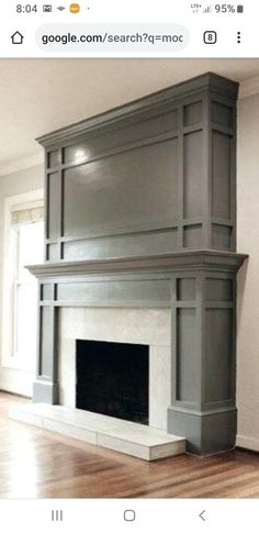 an empty living room with a fireplace and hardwood floors