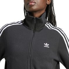 Taking your style back to a simpler time is never the wrong move. And the adidas Firebird Knitted Pinstipe Women's Track Jacket is the perfect example. Besides its classic look brought into the 21st century, this jacket also touts comfort and is easy to match with sweats, jeans, or even a pair of chinos.Regular, relaxed fit. Zip-up. Features adidas three-stripe design. Ribbed hem and cuffs. Has two zippered, front pockets. Fabric: 100% Polyester. Made from 100% recycled materials. Casual Track Jacket With Contrast Stripes For Fall, Sporty Ribbed Outerwear For Fall, Adidas Track Jacket With Three Stripes For Winter, Fitted Casual Outerwear With Contrast Stripes, Casual Fitted Outerwear With Contrast Stripes, Casual Three Stripes Outerwear For Fall, Fitted Outerwear With Three Stripes For Fall, Cotton Outerwear With Three Stripes For Fall, Fitted Three Stripes Outerwear For Fall