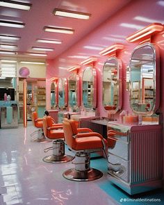 the interior of a hair salon with orange chairs and mirrors on the walls, in front of a pink wall