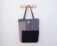 This tote bag, because of its size, perfect for carrying documents, notes ... so it will be a great coworker. But also, for its minimalist style of geometric lines, simple and clean, is also a shoulder bag that will match any of your stylish outfits. This autumn-winter shoulder bag is available in three colours: Grey, black and taupe. - Materials - Outside: 100% wool (taupe colour) - 80% wool/20% viscose (black and grey colours) - Lining: 100% cotton - Handle: vegetable tanned leather (chrome-fr Minimalist Shoulder Bag With Laptop Sleeve, Modern Gray Shoulder Bag For Business, Modern Gray Business Shoulder Bag, Modern Gray Office Bag, Gray Tote Shoulder Bag For Business, Gray Business Tote Shoulder Bag, Gray Rectangular Shoulder Bag For Office, Modern Gray Square Shoulder Bag, Gray Tote Shoulder Bag For Office