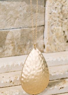 Gold teardrop necklace. Treasure Gold, Hammered Metal, Long Pendant Necklace, Teardrop Pendant, Teardrop Necklace, Long Pendant, Timeless Treasures, Drop Necklace, Round Pendant