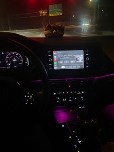 the interior of a car with an electronic display on the dash board and dashboard lights