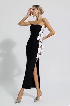 Crafted with elegance and allure, the Noah Black Cutout Bow Bandage Dress exudes timeless sophistication. Its beautifully designed white bow details enhance the tube top, creating a stunning contrast against the black, long silhouette. Perfect for socialite parties and cocktail events, this bandage dress will make a memorable statement.  Dress Length: Approx 125cm Materials: Cotton Gentle Dry Clean Only  Model is 5 ft 7 and wears size S  Colour may vary due to lighting on images. The product ima Strapless Dress With Bow For Black-tie Events, Evening Strapless Bow Strap Sleeveless Dress, Chic Strapless Dress With Bow For Formal Events, Black Evening Dress With Detachable Bow, Black Evening Dress With Bow For Gala, Chic Strapless Dress With Bow For Cocktail, Chic Strapless Dress With Satin Bow For Party, Elegant Strapless Dress With Bow For Evening, Elegant Strapless Dress With Bow Straps For Summer