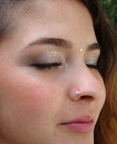 a close up of a person with a nose piercing