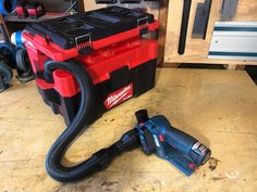 a cordless vacuum and tool on a work bench