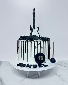 a birthday cake decorated with black and white icing