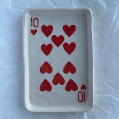 a white tray with red hearts on it