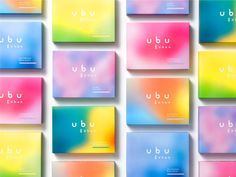 many different colored business cards with the word ubu on them, all in rainbow hues