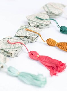 dollar bills and tassels laid out on top of each other