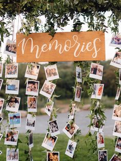 a bunch of pictures hanging from a tree with the word memories written on it and photos attached to them