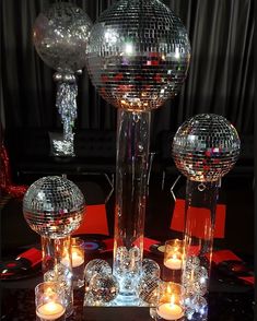 disco ball centerpieces and candles on a table