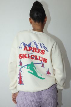 Stay warm and cozy while looking stylish in our Apres Ski Club Pullover Top Cream. This ski slope club cream pullover sweatshirt looks perfect on and off the slopes – its classic design is sure to turn heads! Soft and comfortable, this top is sure to be your favorite addition to your winter wardrobe. Get your Apres Ski Club Pullover Top Cream today and experience the best of off-slope fashion! Ski Club Logo, Ski Sweatshirt, Apres Ski Outfits, Ski Slope, Ski Shirts, Winter Tees, Ski Club, Gift Inspo, Ski Sweater