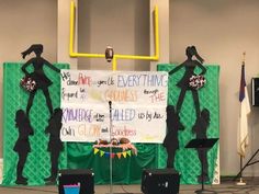 the stage is set up for an event with two women in silhouettes on it