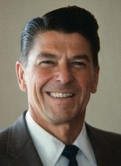 a smiling man in a suit and tie