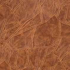 a close up view of an animal skin pattern on a brown leather surface with white stitching