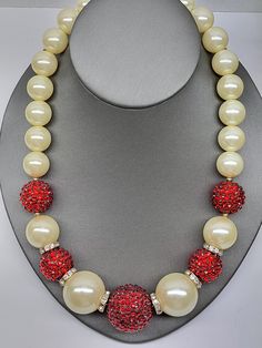 Beautiful vintage VCLM large faux pearl and red crystal pave ball necklace. This is a wonderful holiday necklace measuring 20" long and in very fine condition. I present everything in good standing, and would like you to have a wonderful and positive purchasing experience. Please don't hesitate to reach out to me with offers if you would like to talk about the price I will do what I can. Please take the time to view all pictures. I do my best to photograph the items to show all details. Please ask questions at any time. The items photographed are the actual items in current condition. Some vintage and antique pieces may have some age. I try to concentrate on abnormalities . This will be clearly photographed. Never hesitate to ask for addition photos. If any issues arise Contact me as soon Red Necklaces With Large Beads For Formal Events, Red Necklaces With Large Beads For Formal Occasions, Red Pearl Necklaces For Party, Red Pearl Necklace For Party, Red Necklace For Holiday Party, Red Beaded Pearl Necklace For Party, Party Red Pearl Necklaces, Holiday Red Party Necklace, Red Holiday Party Necklace