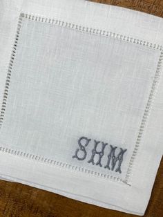 a close up of a piece of cloth with the word shm embroidered on it