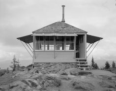 a small building sitting on top of a rocky hill