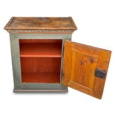 an old wooden cabinet with two doors open