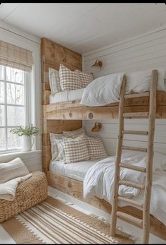 a bedroom with bunk beds and pillows on top of the bed in front of a window