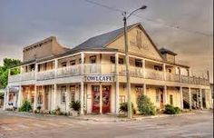 an old building sits on the corner of a street