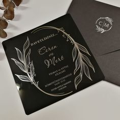 a black and white wedding card with silver foil