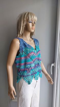 a mannequin wearing a blue and pink crochet top