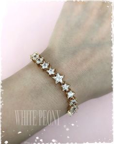 "Starry night collection Celestial cz crystal star adjustable tennis bracelet : \"ERIDANUS\" by ©White Peony by KC. This lovely star bracelet is made with sparkling AAA-quality Cubic Zirconia (zircon, cz, simulated diamond) / champagne gold plated components and adjustable slide clasp, so you can adjust it easily for your wrist (see \"Measures\"). *\"champagne gold\" : yellow gold has \"peach\" hue, between gold - rose gold. Please note that product colors in photos may appear slightly different Star-shaped Cubic Zirconia Jewelry For Party, Star-shaped Cubic Zirconia Wedding Jewelry, White Star-shaped Cubic Zirconia Jewelry, Shooting Star Necklace, Handmade Wedding Jewellery, Starry Night Wedding, Deco Boho, Art Deco Boho, Slide Bracelet